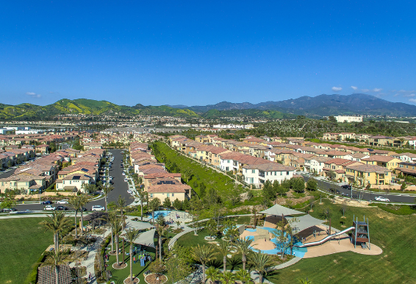 Aerial view of a neighborhood park in Lake Forest California with the foothills in the background under vibrant blue sky.